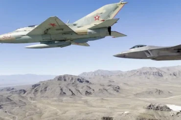 F-22 Raptors Fly with MiG Fighters Over Nellis to Honor Red Eagles Founder Col. Gail Peck