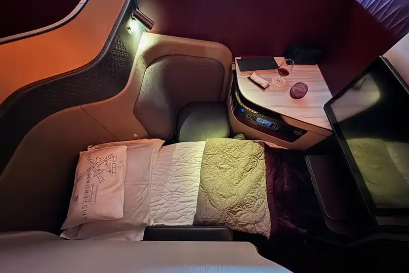 lie-flat bed and turndown service inside Qatar Airways Qsuite qsuite