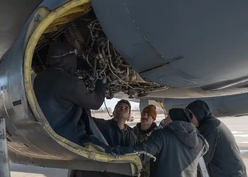 maintenance crew working on vintage b-52 fuselage