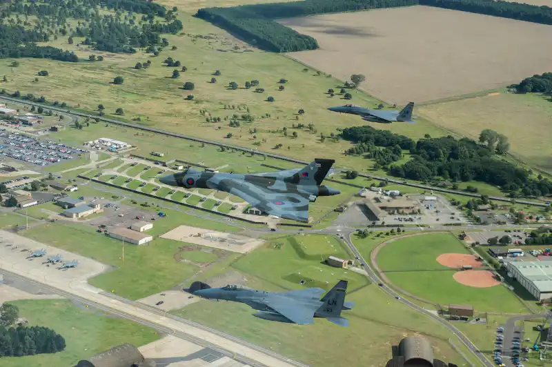 Avro Vulcan XH558, accompanied by an F-15C Eagle fly over RAF Lakenheath