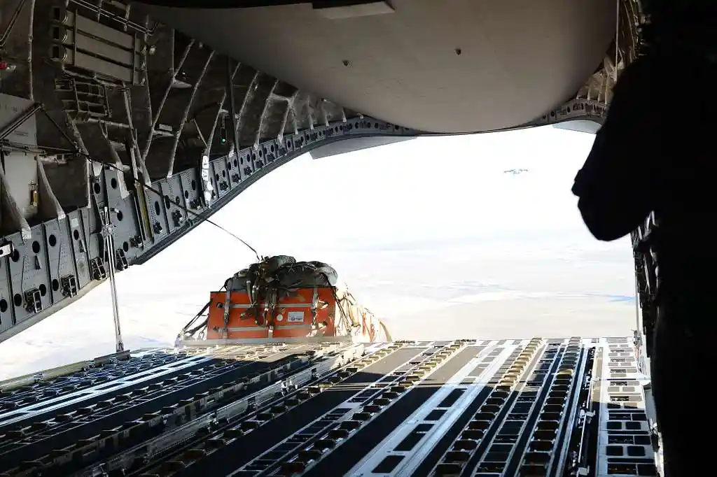 C-17 Globemaster III airdrop mission with cargo pallets exiting rear ramp