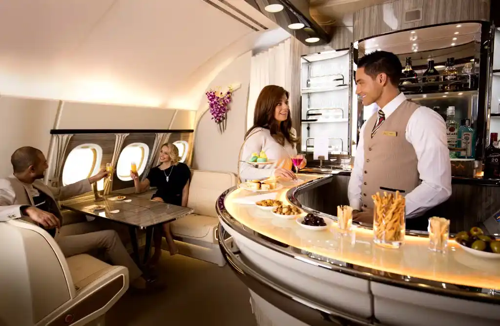 Emirates Boeing 777X mid cabin social lounge with snack bar and sofa seating