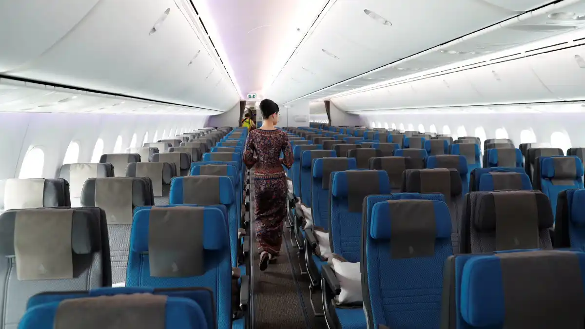 cramped modern economy airline seating with narrow legroom