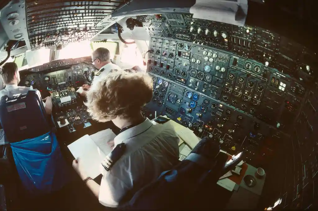 flight engineer monitoring analog aircraft systems on Boeing 747