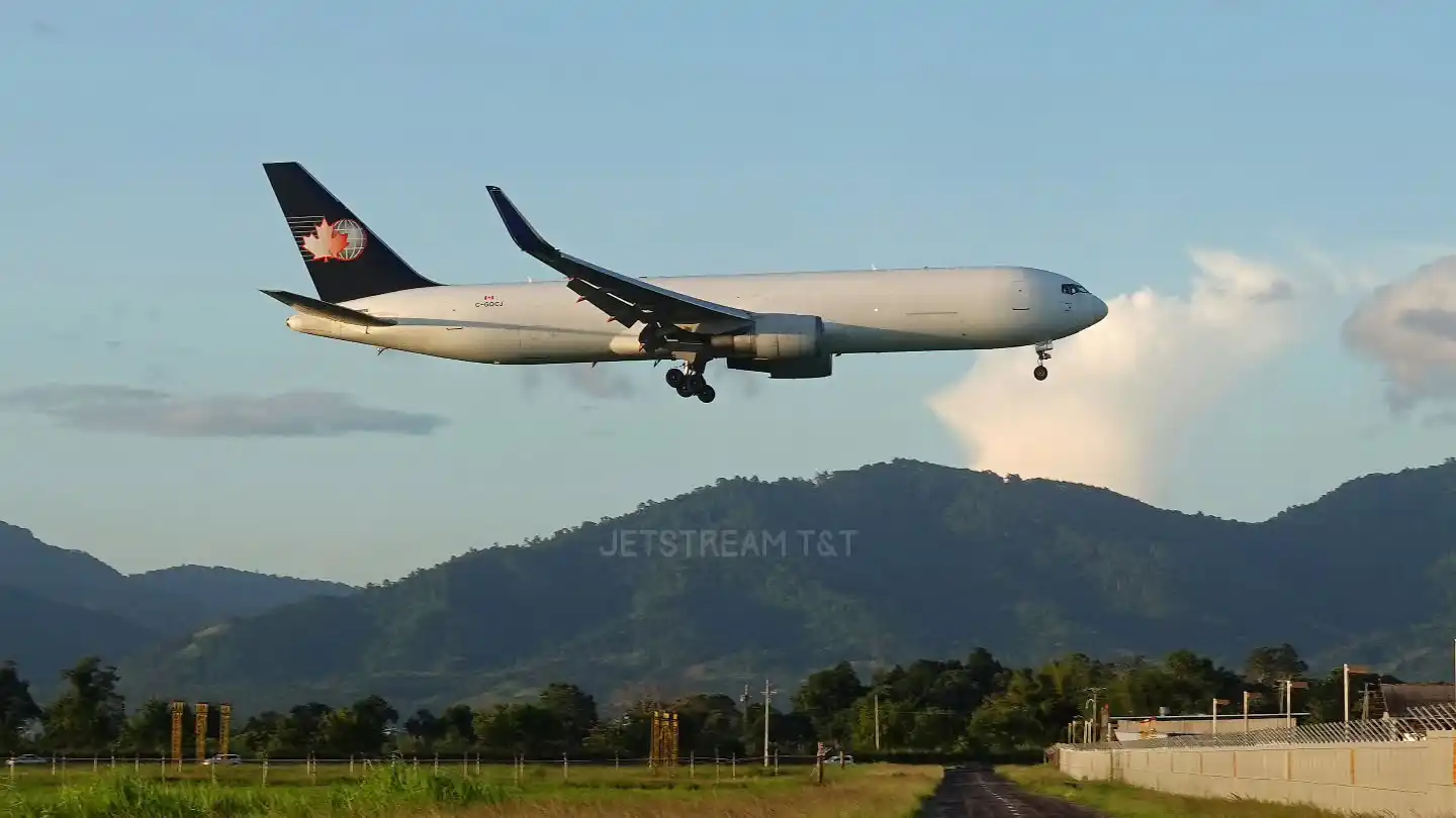Boeing 767 freighter flying above ocean sunset cargo route long haul logistics