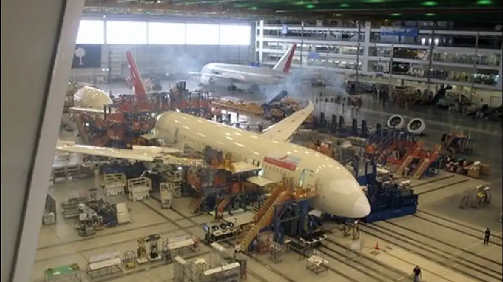 Technicians disassembling a Boeing 787 engine for parts recovery