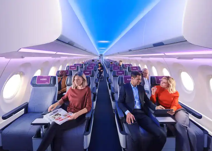 Passenger inside Airbus A220 modern Airspace cabin during boarding