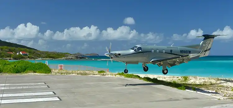 Tourists watching aircraft land from St. Jean hill overlooking SBH runway