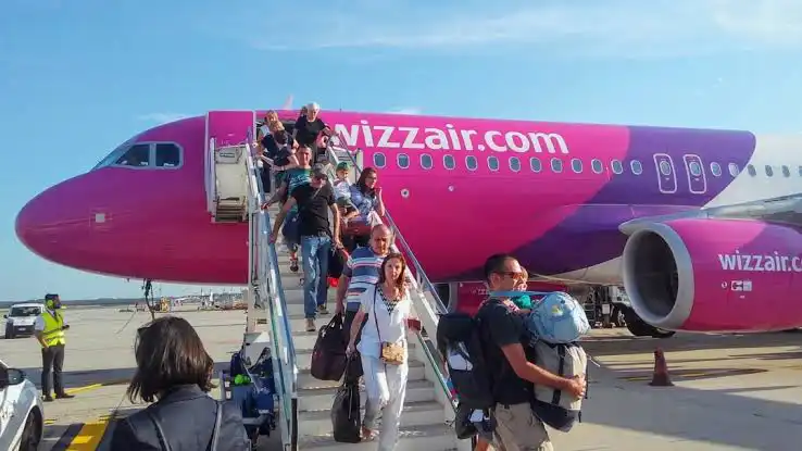 European travelers boarding Wizz Air low cost airline flight