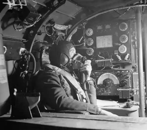 World War II fighter pilots using radio communication inside aircraft cockpit
