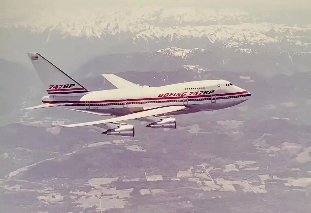 Boeing 747SP in flight at high altitude above clouds showing its shortened fuselage and long wings