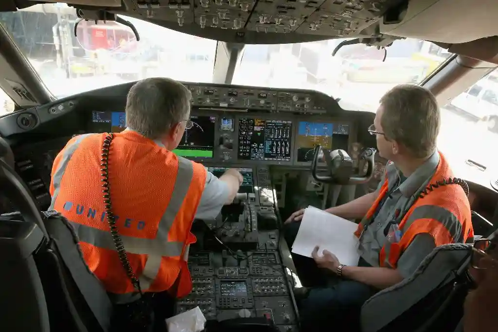 Boeing 787 maintenance technicians performing aircraft software power reset