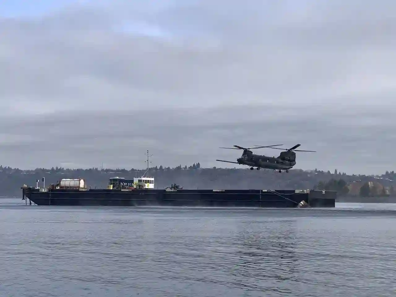 SM300 autonomous crewless barge navigating open water for MH-47G helicopter resupply testing